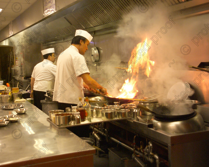 D5780804 
 Oriental chefs at work in a Chinese restaurant - Peterborough 
 Keywords: Woks, chef, kitchen, hot wok, Oriental cooking, Oriental, Chinese, wok cooking, cuisine, restaurant,