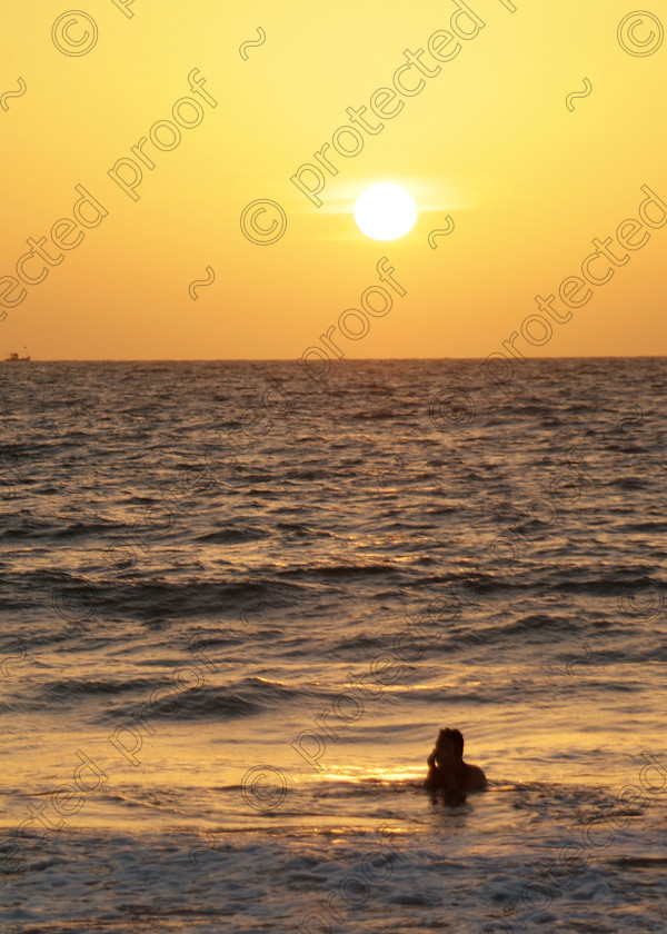 Goa A 080 
 Sunset at Varca Beach, Goa 
 Keywords: sunset, sun, sea, sky, Arabian Sea, swimmer, Varca, Goa, Salcette, India, Southern India, travel, tourism,