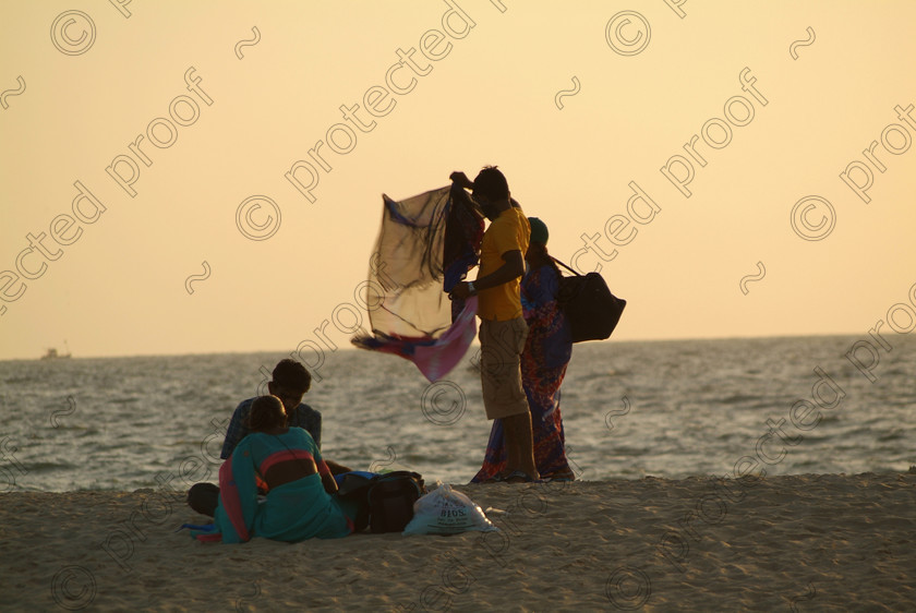 Goa A 049 
 Traders at dusk; Varca Beach, Goa 
 Keywords: traders, people, sand, sea, sky, beach, Varca, Salcette, India, Southern India, Goa, Arabian Sea, ethnic people, travel, tourism,