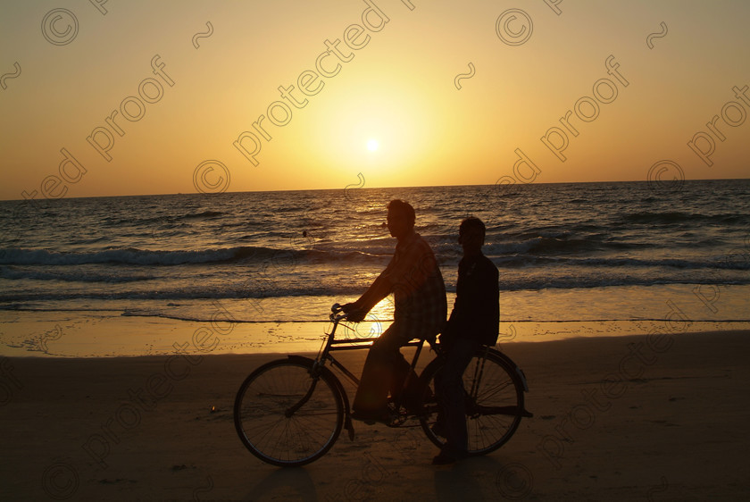 Goa A 067 
 Bicycle riders at sunset, Varca Beach, Goa 
 Keywords: bicycle riders, silhouette, sunset, sun, sand, sea, sky, Varca, beach, Salcette, India, Southern India, Arabian Sea, people, travel, tourism,